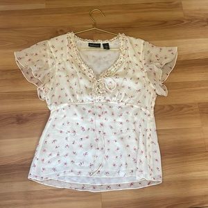 White silk blouse worth small red flowers.